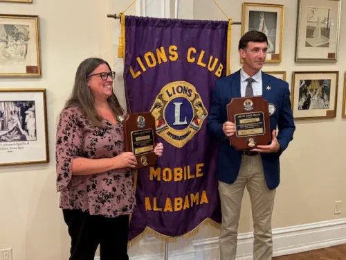 Mobile Club awards Melvin Jones Fellowships to Lions Jennifer Holifield and Andrew Peak.